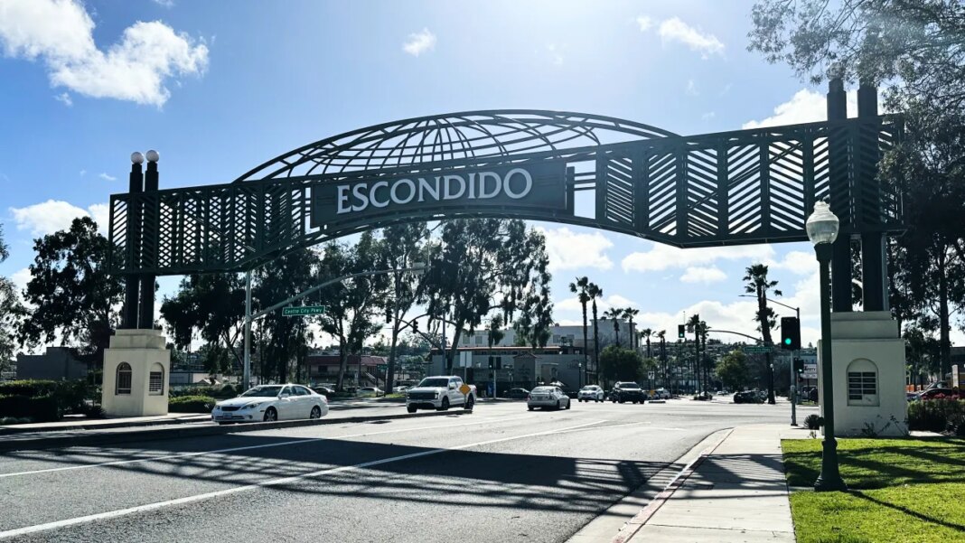 Motorists drive under a city sign on Wednesday, Feb. 18, 2026 in Escondido, Calif. (AP Photo/Amy Taxin)