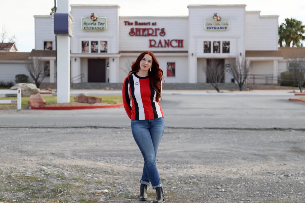 A sex worker, who goes by the name Molly Wilder, poses for a photo in front of Sheri