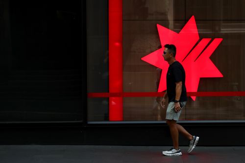 SYDNEY, AUSTRALIA - FEBRUARY 18: A pedestrian moves past a National Australia Bank Ltd. (NAB) central business district branch  on February 18, 2025 in Sydney, Australia. The Reserve Bank of Australia (RBA) is set to announce its monetary policy decision on February 18, 2025, with many experts predicting a rate cut due to easing inflation and economic conditions. This anticipated cut aims to provide relief to mortgage holders and stimulate economic activity amid concerns about weak household con