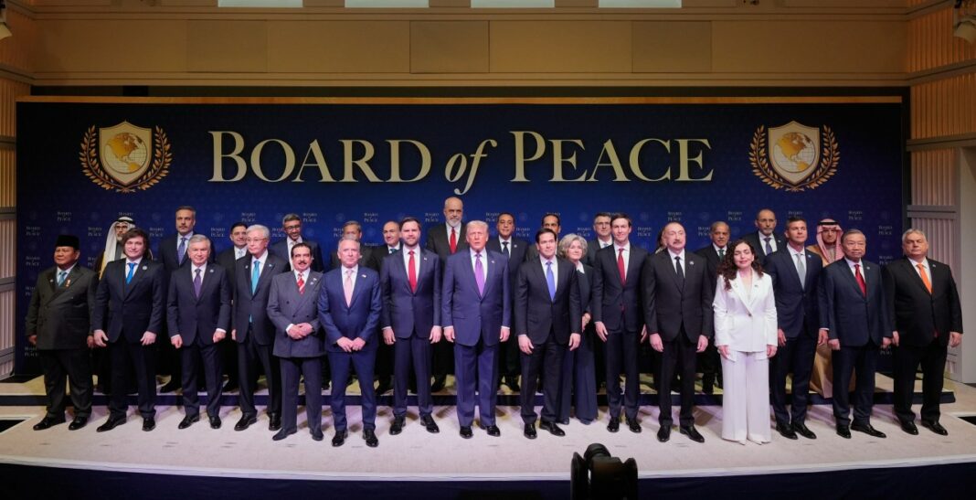 President Donald Trump stands with other World leaders before a Board of Peace meeting at the U.S. Institute of Peace, Thursday, Feb. 19, 2026, in Washington. (AP Photo/Mark Schiefelbein)
