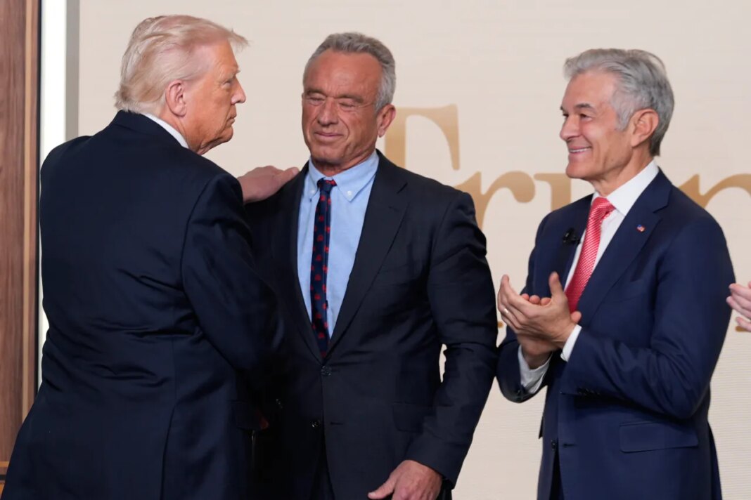 President Donald Trump greets Health and Human Services Secretary Robert F. Kennedy Jr. and Centers for Medicare & Medicaid Services administrator Dr. Mehmet Oz after en event about TrumpRx in the South Court Auditorium in the Old Eisenhower Executive Office Building on the White House campus, Thursday, Feb. 5, 2026, in Washington. (AP Photo/Alex Brandon)
