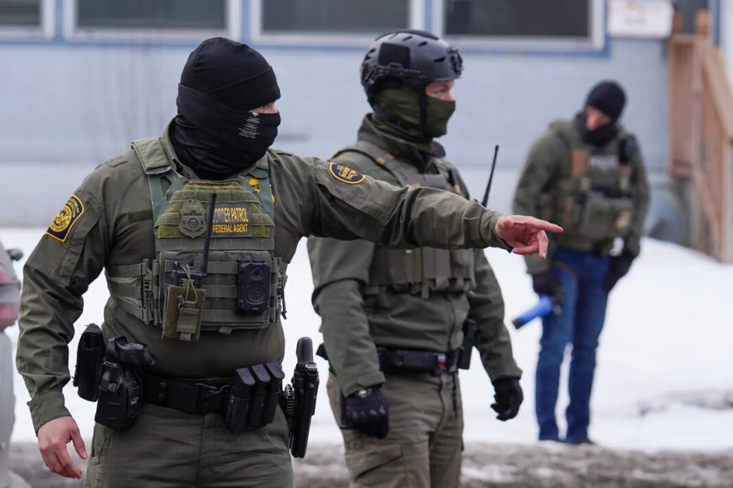 A United States Border Patrol agent gestures to a car while conducting immigration enforcement operations, Thursday, Feb. 5, 2026, in Minneapolis. (AP Photo/Ryan Murphy)