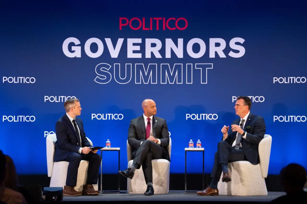 Politico Correspondent Adam Wren, Gov. Wes Moore, D-Md., and Gov. Kevin Stitt, R-Okla., participate at an event at the National Governors Association Winter Meeting, Thursday, Feb. 19, 2026, in Washington. (AP Photo/Allison Robbert)