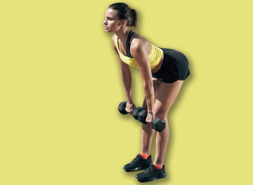 Workout. Fitness woman doing exercise with weights at street. Fit girl athlete exercising, doing dumbbell deadlift outdoors