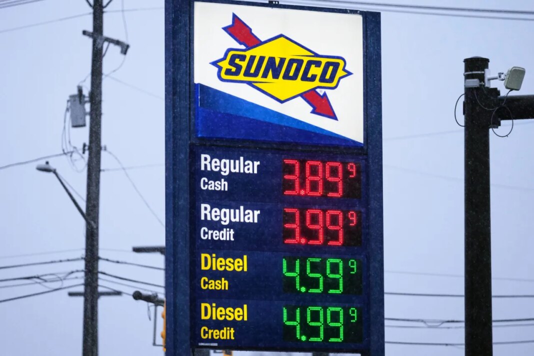 Gas prices are displayed at a gas station in Parma, Ohio, Thursday, March 26, 2026. (AP Photo/Sue Ogrocki)