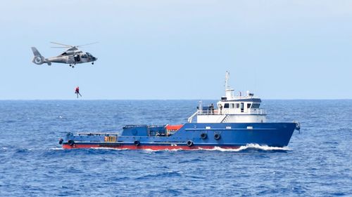 The crew, who claim they were simply delivering the ship to its new Australian owner, have no idea when or how they'll get home.