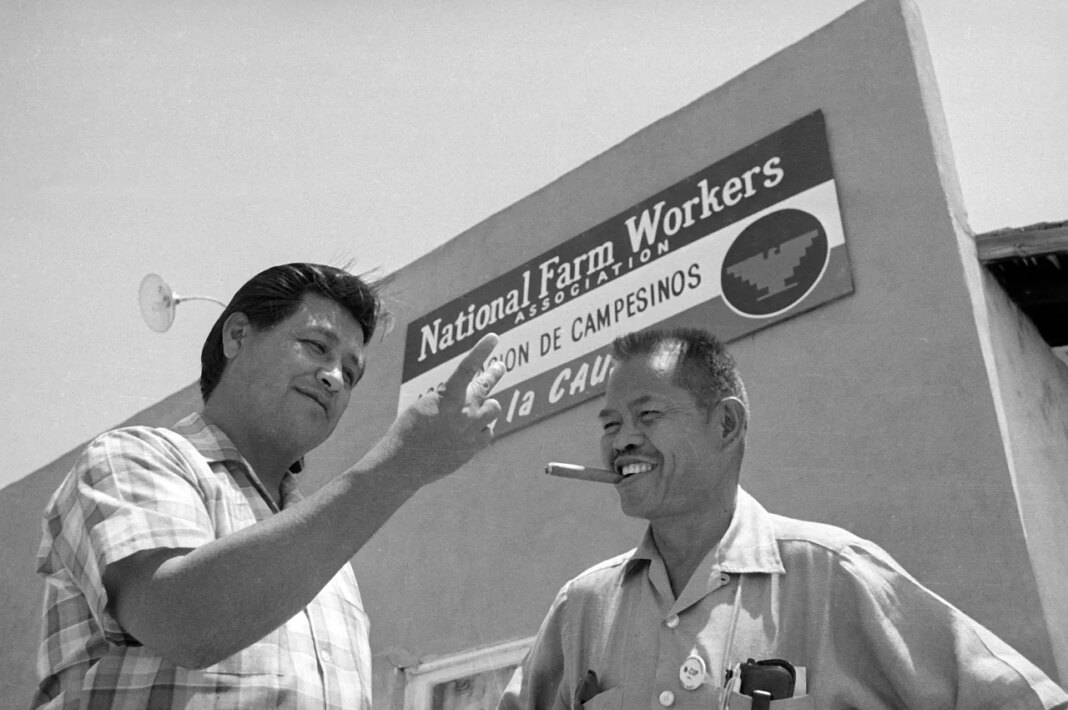 FILE - United Farm Workers leader Cesar Chavez, left, who led the fight as head of the AFL-CIO union local, talks with Larry Itliong, leader of the Filipino Agriculture Workers Organizing Committee, in front of union headquarters at Delano, Calif., July 28, 1967. (AP Photo/Harold Filan, File)