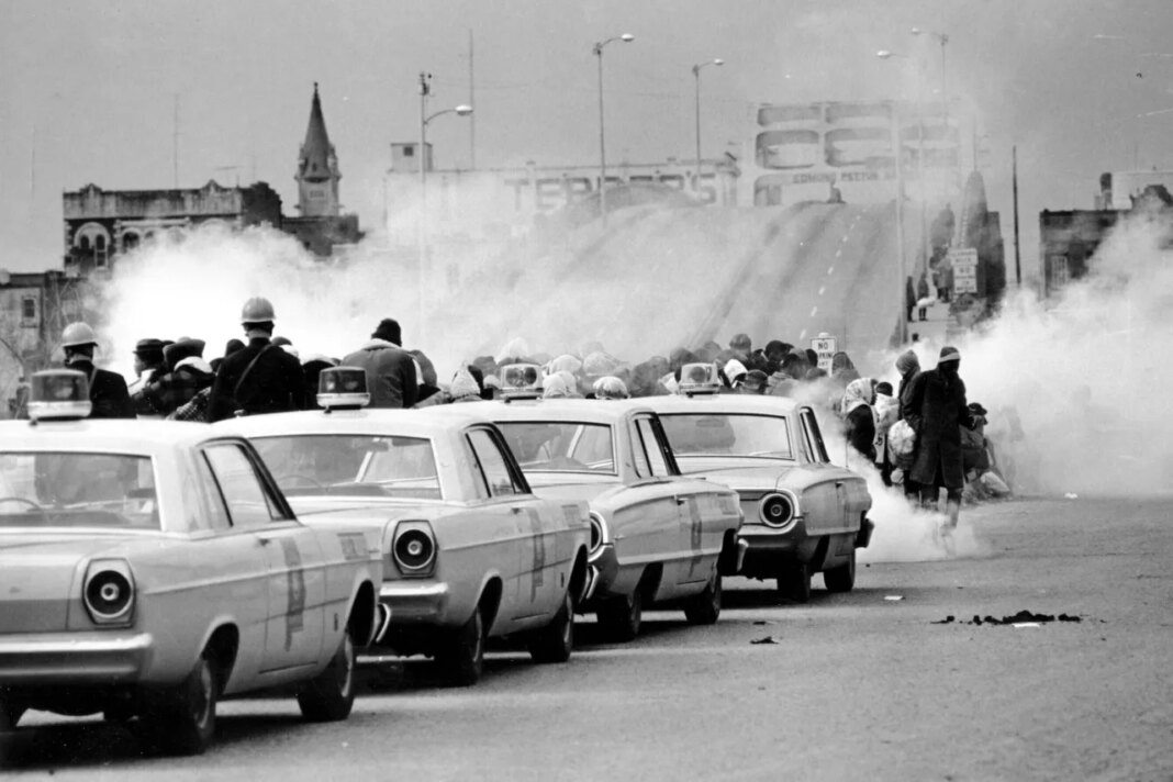 FILE - Tear gas fills the air as state troopers, ordered by Gov. George Wallace, break up a march at the Edmund Pettus Bridge in Selma, Ala., on Sunday, March 7, 1965. (AP Photo/File)