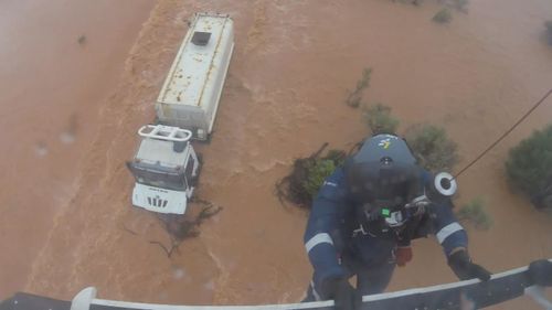 One crew member was winched down, balancing on top of the cabin as the driver clung on.He attached the harness and both were brought to safety