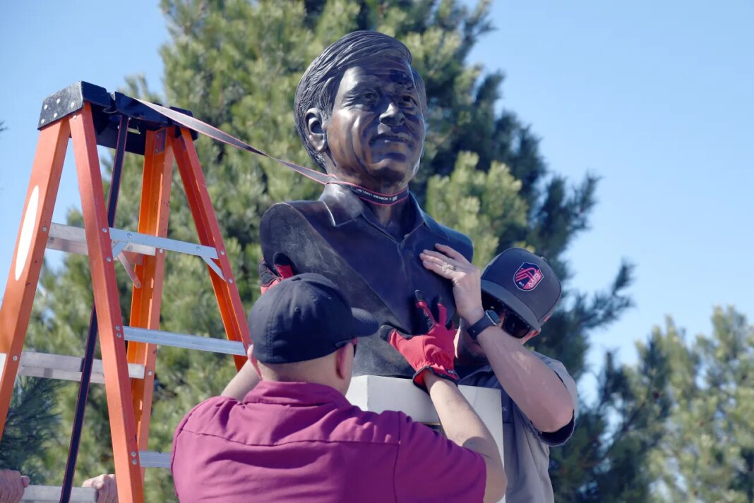 FILE - City workers remove a bust of César Chavez at César E. Chavez Park in Denver on Thursday, March 19, 2026. (AP Photo/Thomas Peipert, file)