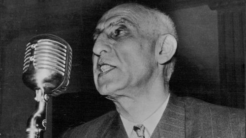 Persian Politicians; Dr. Muhammad Mossadeq -- Persia's Prime Minister and Minister of National Defence, photographed whilst delivering an impassioned radio address. June 10, 1953. 