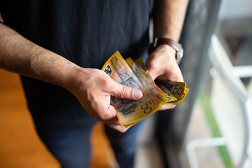 Cash stock image of cash person holding cash Australian money