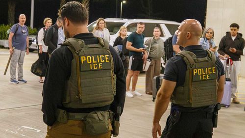 ICE agents outside Louis Armstrong International Airport.
