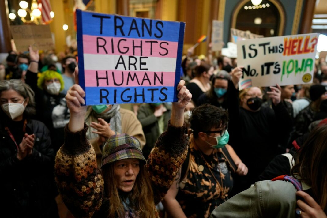 FILE - Protesters fill the Iowa state Capitol to denounce a bill that would strip the state civil rights code of protections based on gender identity, Thursday, Feb. 27, 2025, in Des Moines, Iowa. (AP Photo/Charlie Neibergall, File)