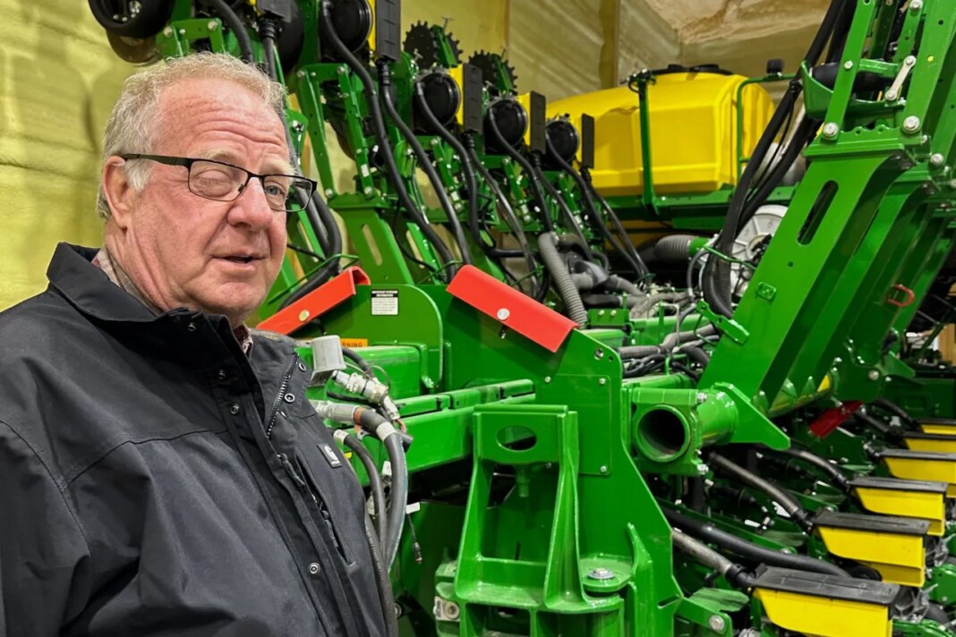 Tom Waters, a seventh-generation farmer, stands next to his planting machinery Friday, March 13, 2026, in Orrick, Mo. (AP Photo/Nick Ingram)