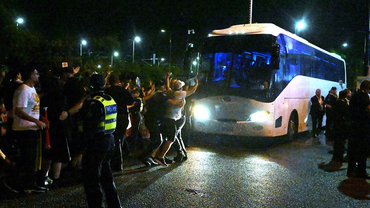 Iranian soccer stars beg for help while protesters surround their bus as team face possible death sentence for brave anthem boycott in Australia