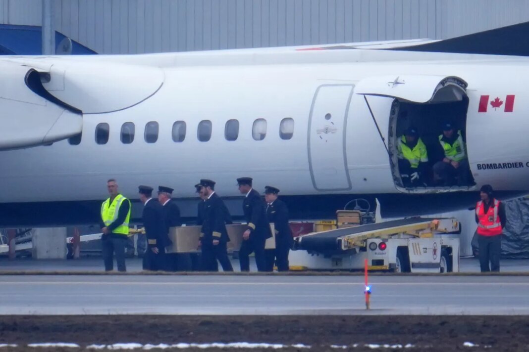 Pilots carry the casket during the repatriation of Jazz Aviation First Officer Mackenzie Gunther, in Ottawa, Ontario, Thursday, March 26, 2026. Gunther died Sunday after his Air Canada Express plane collided with a fire truck at New York