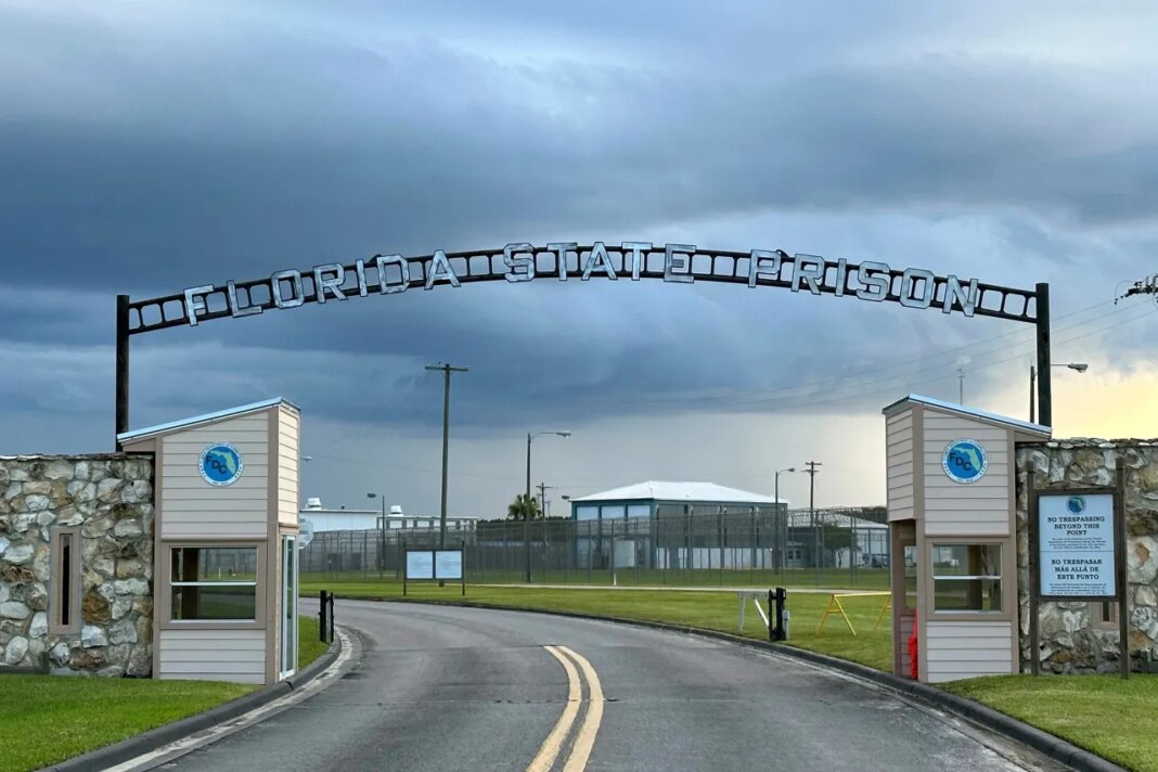 FILE - Clouds hover over the entrance of the Florida State Prison in Starke, Fla., Aug. 3, 2023. (AP Photo/Curt Anderson, File)