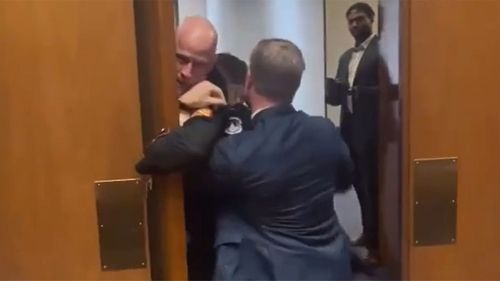 Tim Sheehy was dragging a protester out of a hearing when his arm broke.