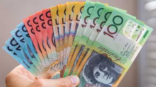 hand holding assortment of Australian cash notes