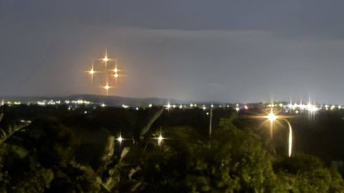 Wild theories have emerged as mysterious "glowing orange orbs" were seen in the sky across parts of the NSW Hunter region. 