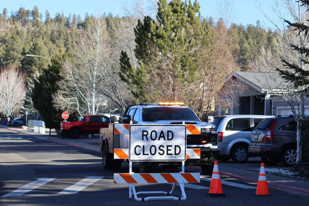 CORRECTS DATE: FILE - Law enforcement officers respond to a neighborhood in Flagstaff, Ariz., where police say a man opened fire on police on Feb. 4, 2026. (AP Photo/Cheyanne Mumphrey, File)
