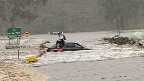 Rescues and road closures as flooding rain moves across Queensland