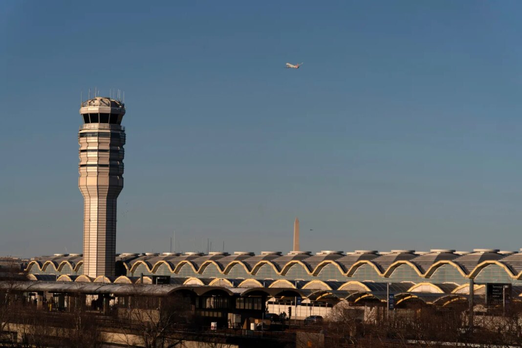 FILE - The air traffic control tower at Ronald Reagan Washington National Airport is seen, Feb. 1, 2025, in Arlington, Va., near the wreckage of a mid-air collision between a Black Hawk helicopter and an American Airlines jet in the Potomac River. (AP Photo/Jose Luis Magana, File)