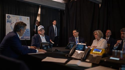 A map seen in the background of this photo in Donald Trump's Mar-a-Lago situation room reveals the position of US forces, as well as other intel during Operation Epic Fury.