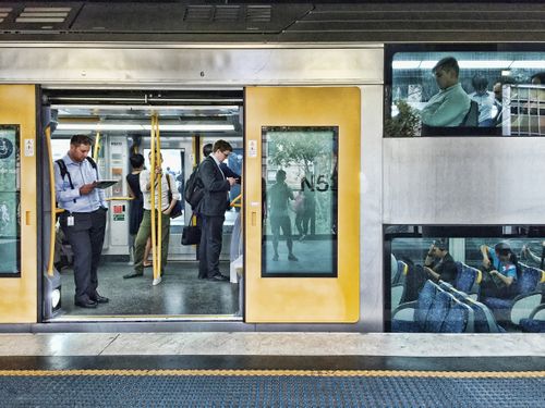 Sydney, NSW, Australia - March 12, 2015. People standing and sitting on the Cityrail train in Sydney. Trains in Sydney have two levels for seating.