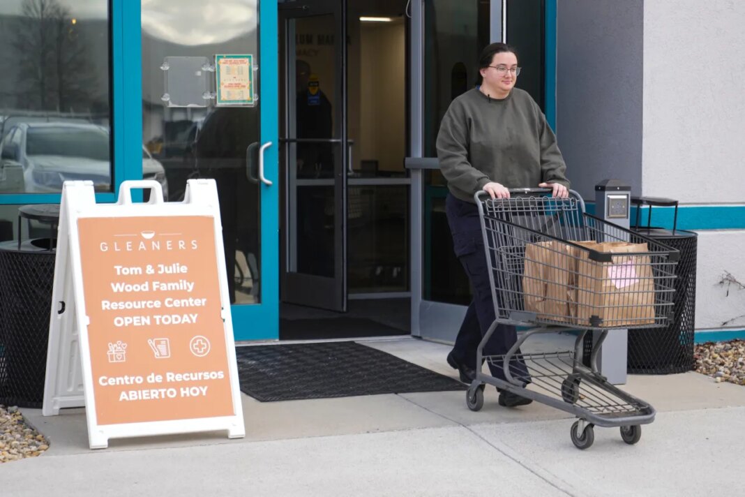 Taylor Desert, a TSA agent, leaves Gleaners Food Bank after picking up groceries in Indianapolis, Monday, March 23, 2026. (AP Photo/Michael Conroy)