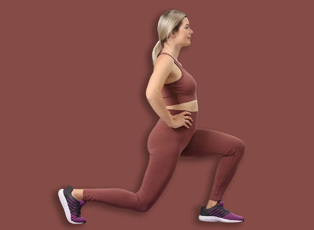 Online fitness trainer. Woman doing exercise near laptop at home