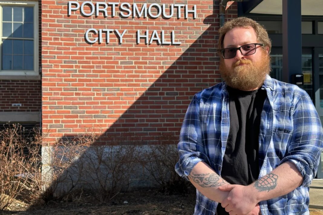 Joshua Bogdan, who faced new hurdles while registering to vote last year, poses in front of City Hall in Portsmouth, N.H., Tuesday, March 10, 2026. (AP Photo/Holly Ramer)