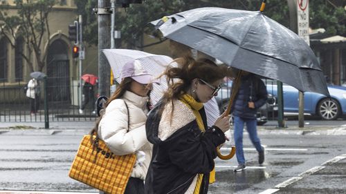 Pedestrians in the rain on Broadway on Thursday 21st August 2025. 