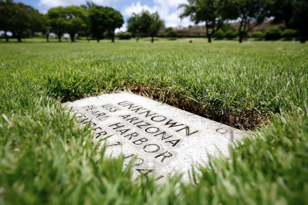 FILE - A grave marker for an unknown casualty from the USS Arizona is shown at the National Memorial Cemetery of the Pacific, July 15, 2021, in Honolulu. (AP Photo/Caleb Jones, File)