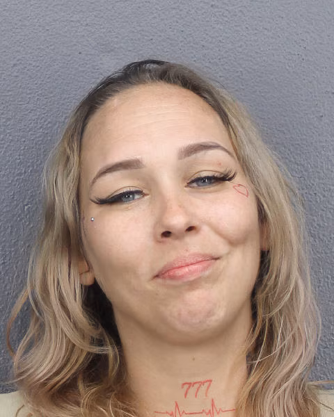 Woman Smiles Eerily in Mugshot After Allegedly Shooting Sister