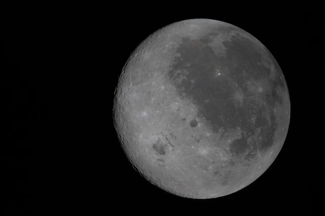 This image provided by NASA Monday, April 6, 2026, shows the Moon, the near side (the hemisphere we see from Earth) visible at the right side of the disk, identifiable by the dark splotches. At lower left is Orientale basin, a nearly 600-mile-wide crater that straddles the Moon’s near and far sides. Everything to the left of the crater is the far side. (NASA via AP)