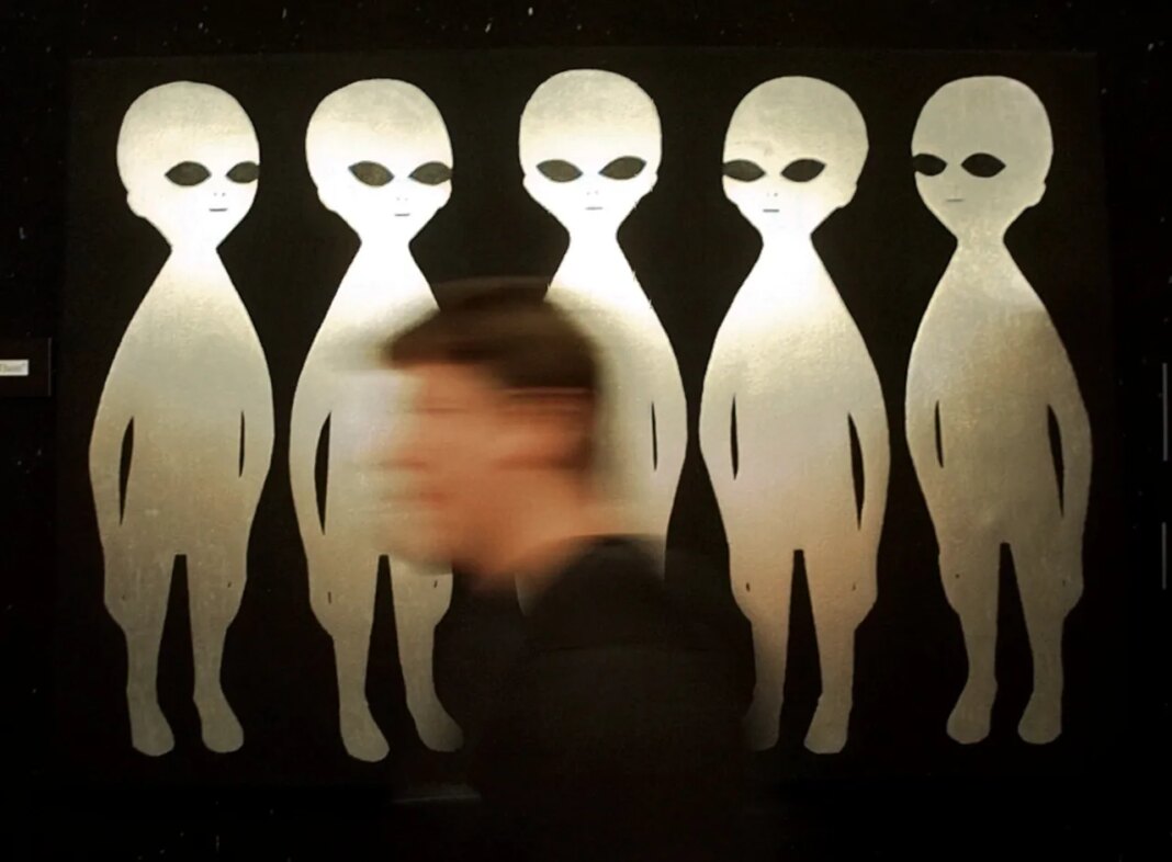 FILE - A patron passes a painting inside the International UFO Museum and Research Center in Roswell, N.M., on June 10, 1997. (AP Photo/Eric Draper, File)