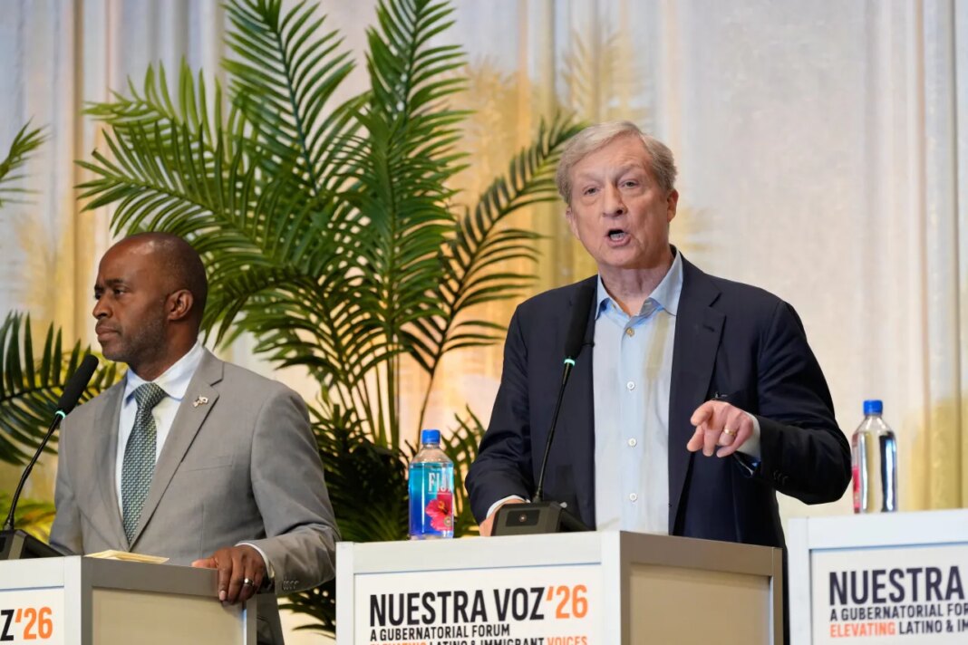 Tom Steyer, right, speaks beside Tony Thurmond during a gubernatorial candidate forum on Latino and immigrant communities in Sacramento, Calif., Tuesday, April 14, 2026. (AP Photo/Godofredo A. Vásquez)