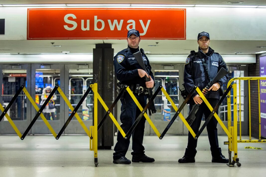 FILE - Police stand guard inside the Port Authority Bus Terminal following an explosion near Times Square, Dec. 11, 2017 in New York. (AP Photo/Andres Kudacki, File)