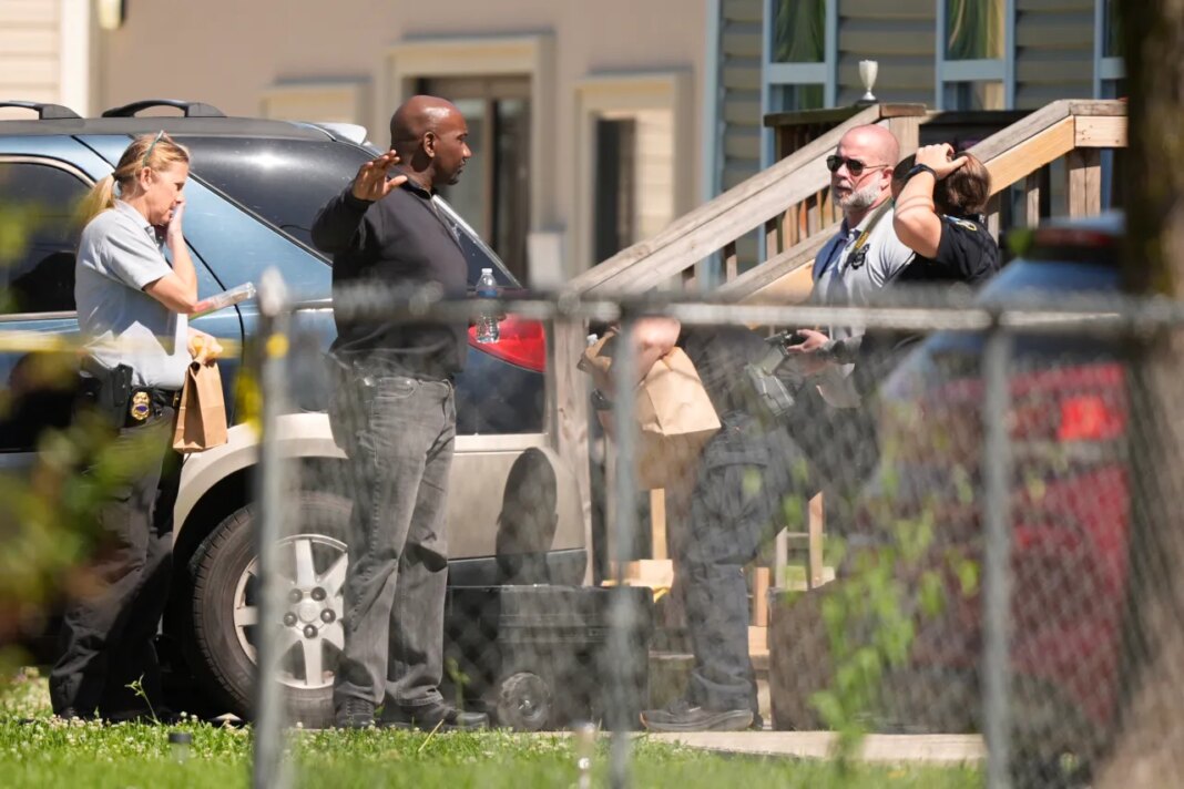 Police work outside the scene of a mass shooting, Sunday, April 19, 2026, in Shreveport, La. (AP Photo/Gerald Herbert)