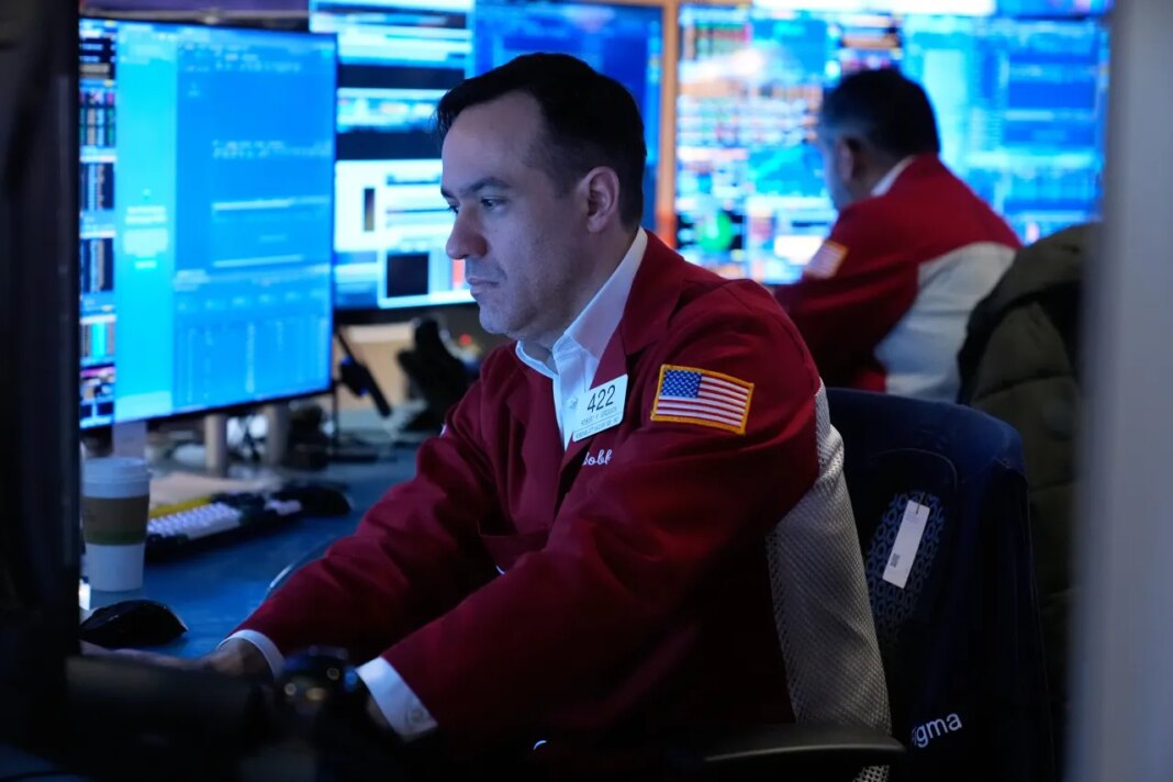 Robert Greason works on the floor at the New York Stock Exchange in New York, Tuesday, April 7, 2026. (AP Photo/Seth Wenig)