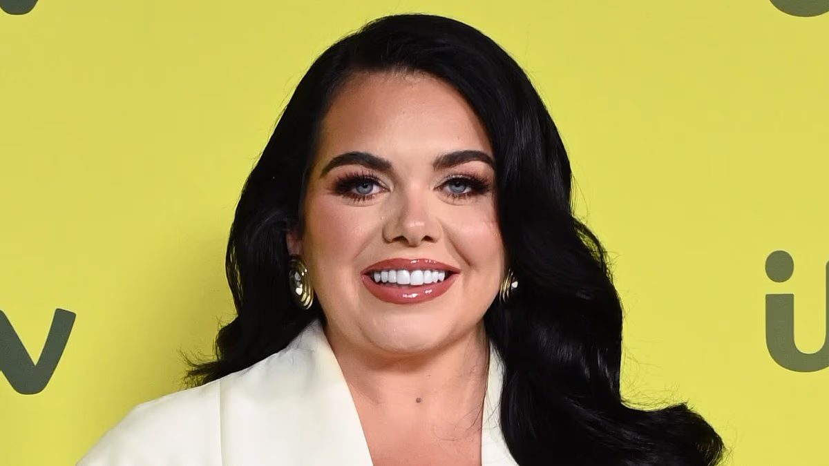 Pregnant Scarlett Moffatt cradles her baby bump in a stylish white dress as she attends the ITV showcase