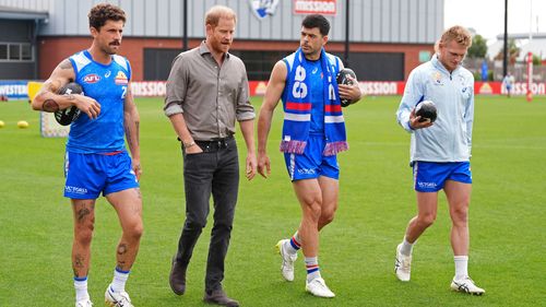 Prince Harry, center left, The Duke of Sussex, meets Western Bulldogs players during a visit to Movember at the Western Bulldogs HQ at Mission Whitten Oval, in Footscray, a suburb of Melbourne, Australia Wednesday, April 15, 2026. (Jonathan Brady/Pool Photo via AP)