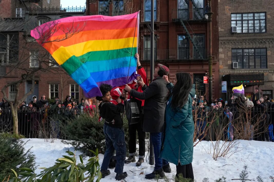 FILE - New York politicians and activists raise a rainbow flag on a pole in Christopher Park across the street from the Stonewall Inn, Thursday, Feb. 12, 2026, in New York, a few days after it was removed by the National Park Service to comply with guidance from the Trump administration. (AP Photo/Yuki Iwamura, File)