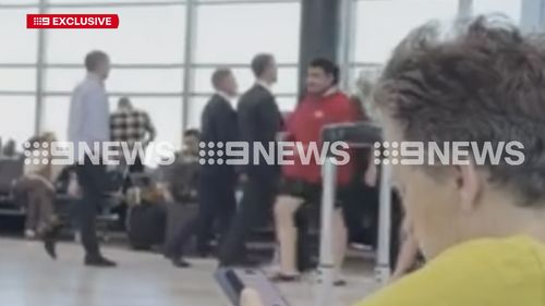 Federal Taskforce officers march through Sydney Airport's domestic terminal before the arrest of Ben Roberts-Smith.