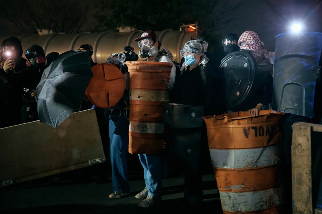 Protestors barricade the entrance gates outside the Delaney Hall detention on Wednesday, May 27, 2026, in Newark, N.J. Inside the facility, detainees carried out a labor and hunger strike for days over alleged living conditions. (AP Photo/Andres Kudacki)