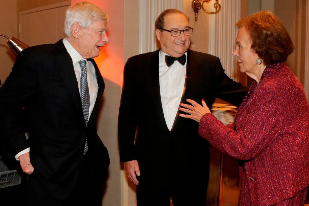 FILE - In this June 17, 2015 photo, Anti-Defamation League National Director Abe Foxman, center, greets ADL education committee co-chair Charlotte Frank, right, and Fred Malek during a reception for a dinner in Foxman