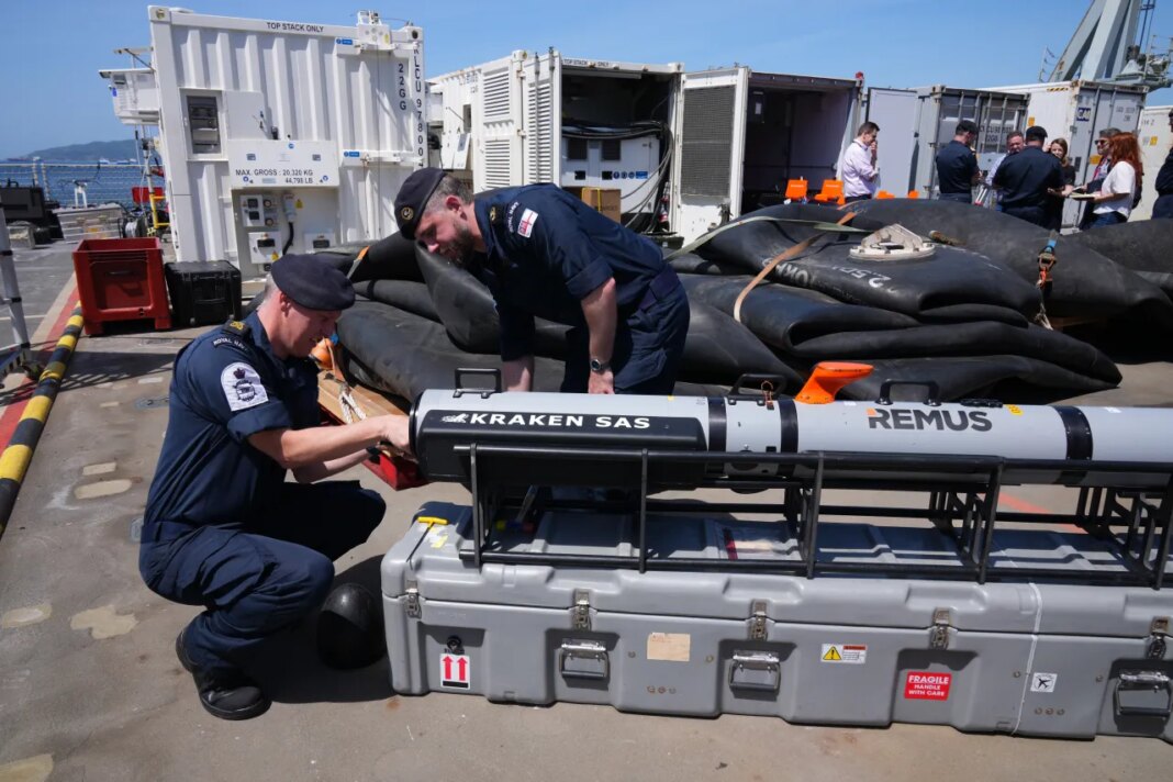 UK Royal Navy personnel inspect autonomous vehicles with sonar sensor that can detect and identify mines, on RFA Lyme Bay in territory of Gibraltar, on Friday, May 22, 2026. (AP Photo/Kwiyeon Ha)