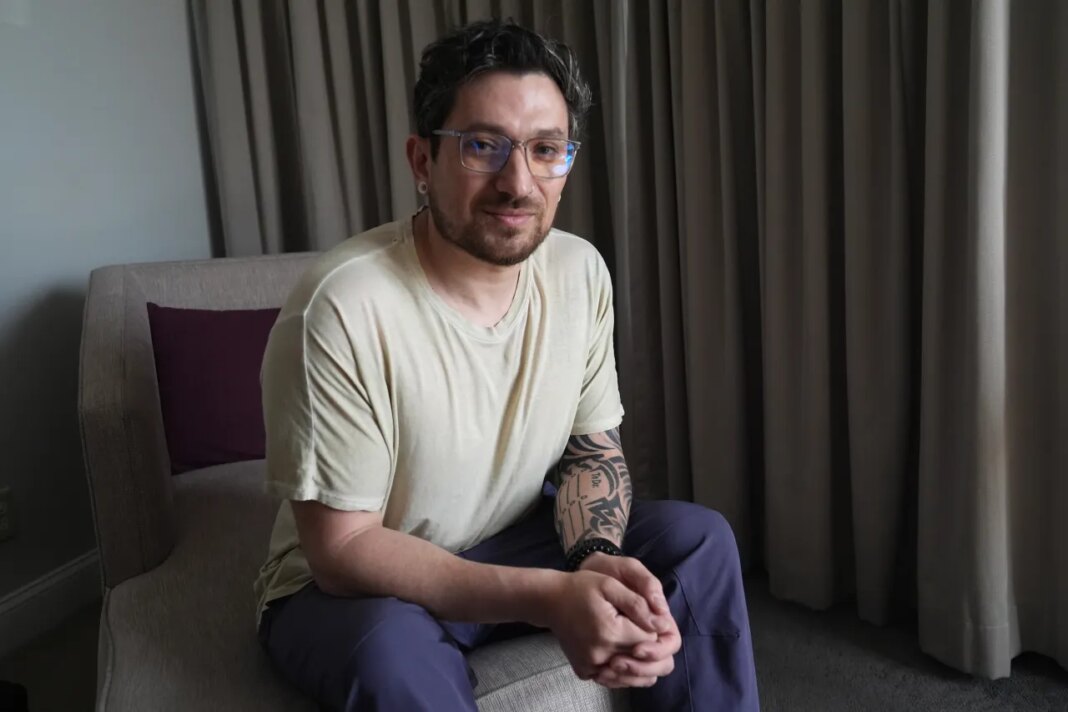 Kyle Adler, a 36-year-old Chilean American taken from his family at nine months old and illegally adopted, poses for a photo in Miami, Friday, Feb. 13, 2026, before heading to the airport to travel to Chile to meet his birth mother. (AP Photo/Marta Lavandier)